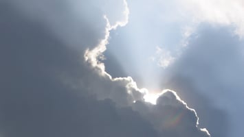 Silver lining of the clouds with sunlight shining behind
