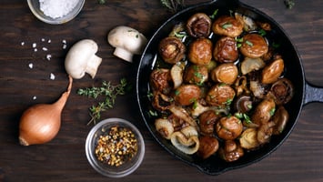 Vegan Mushrooms cooked in a cast iron pan with raw truffles and spices